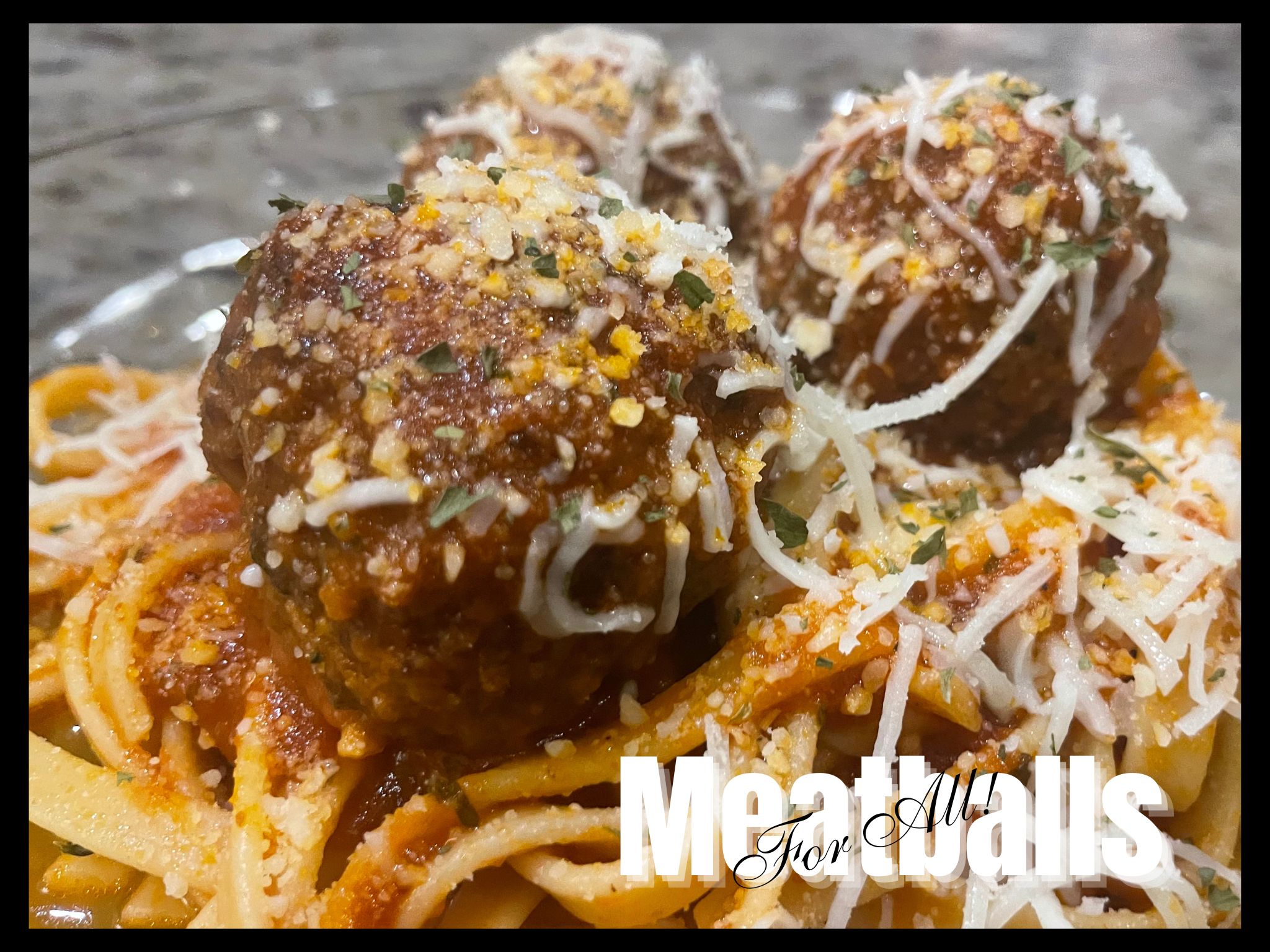 Meatballs For all - Close up Image of spaghetti and meatballs smothered in cheeses